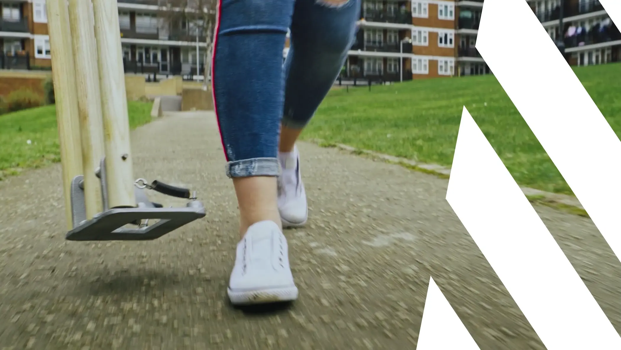 A person wearing white shoes and blue jeans. Description generated by AI