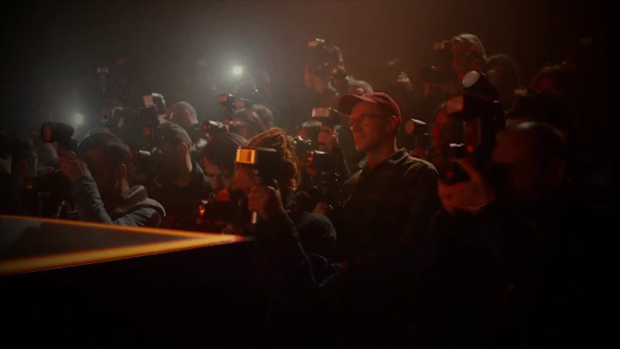 A crowd of people with cameras. Description generated by AI